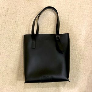 Black leather shoulder tote style bag.